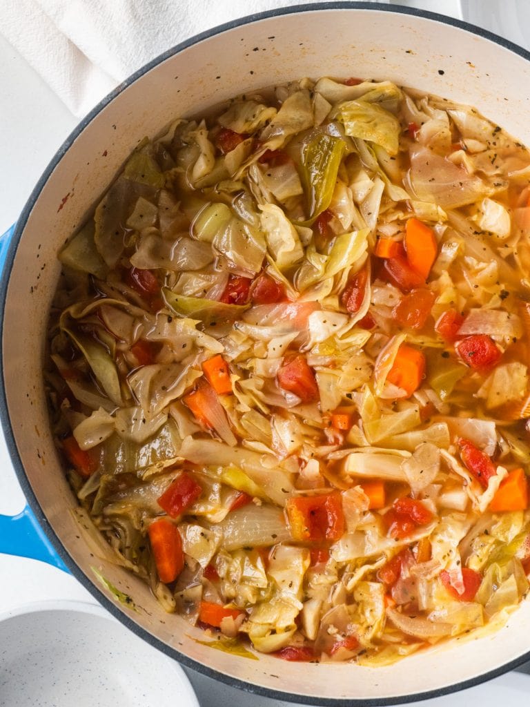 a bowl of cabbage soup in blue pot