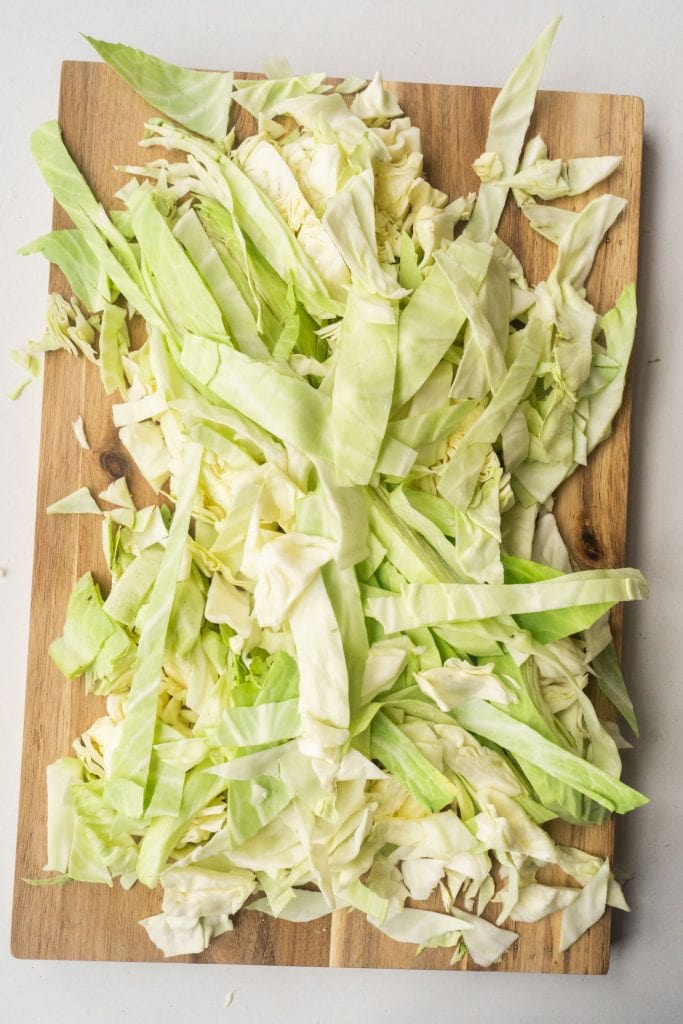 chopped up cabbage on wooden cutting board