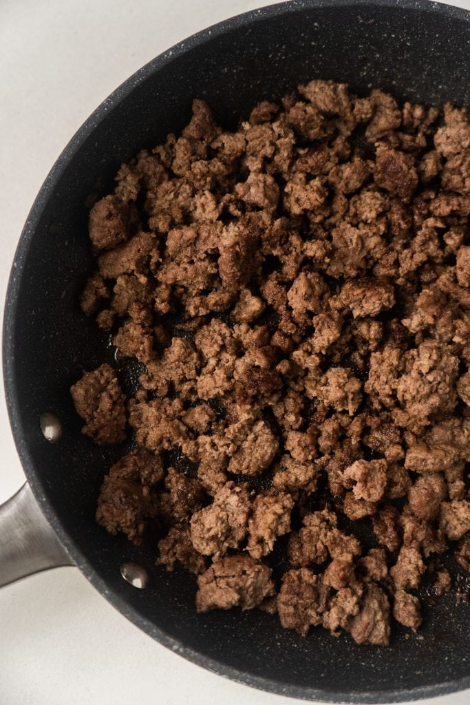 ground beef in skillet that's been browned.