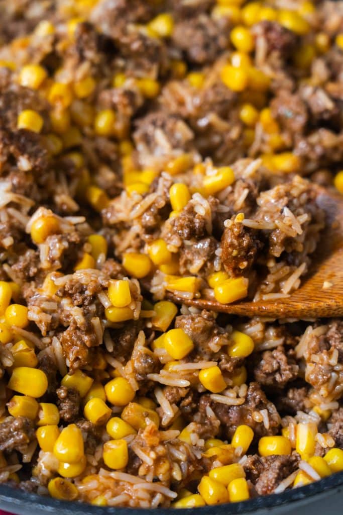melted cheese with ground beef and corn in skillet.