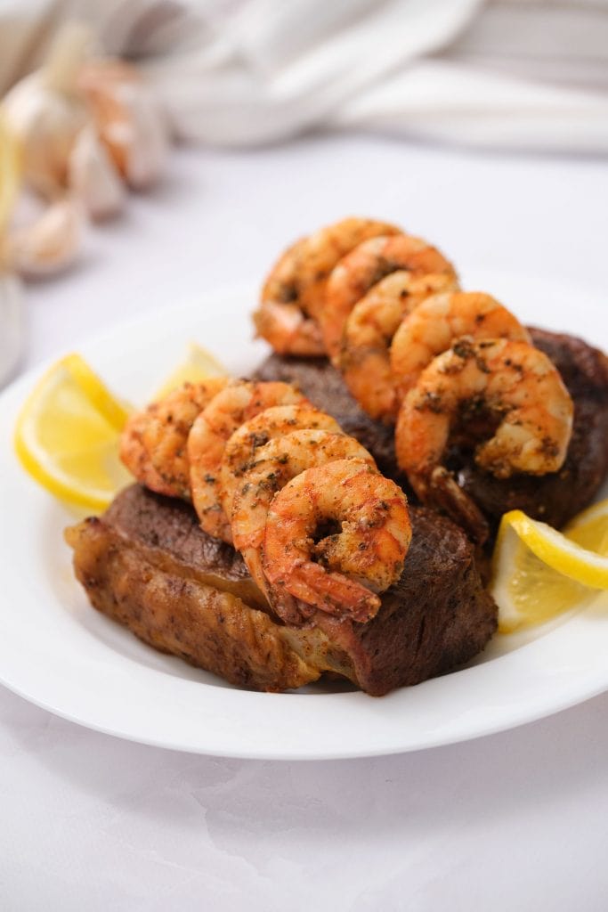 Easy Surf and Turf for two recipe.  Shrimp is marinated for 30 minutes, and then cooked with New York strip steaks on the stove top.  This makes a simple special dinner!
