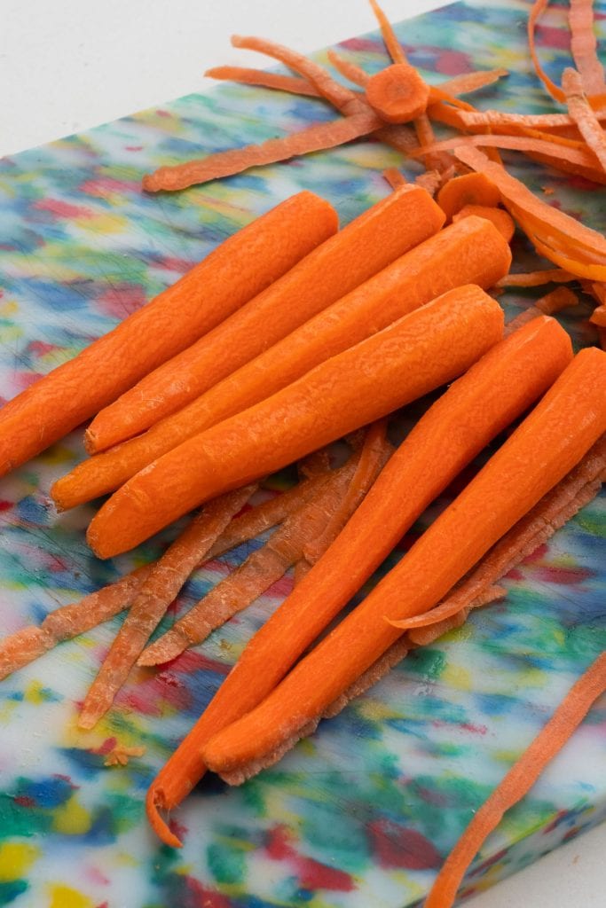 carrots peeled on cutting board. 