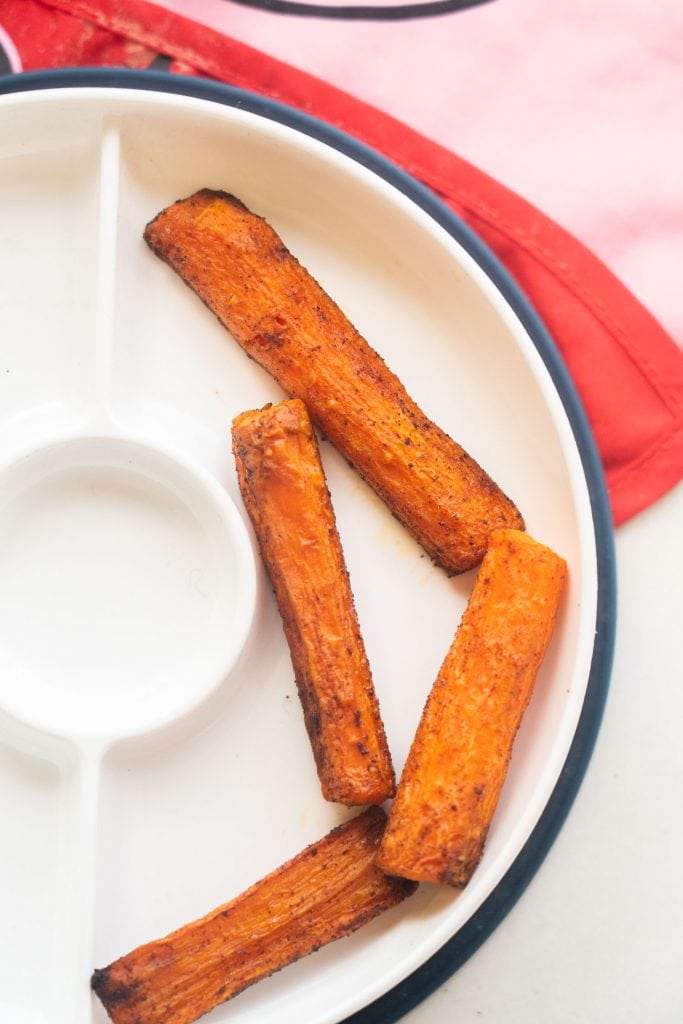 cinnamon carrot fries for baby led weaning on kids white plate.