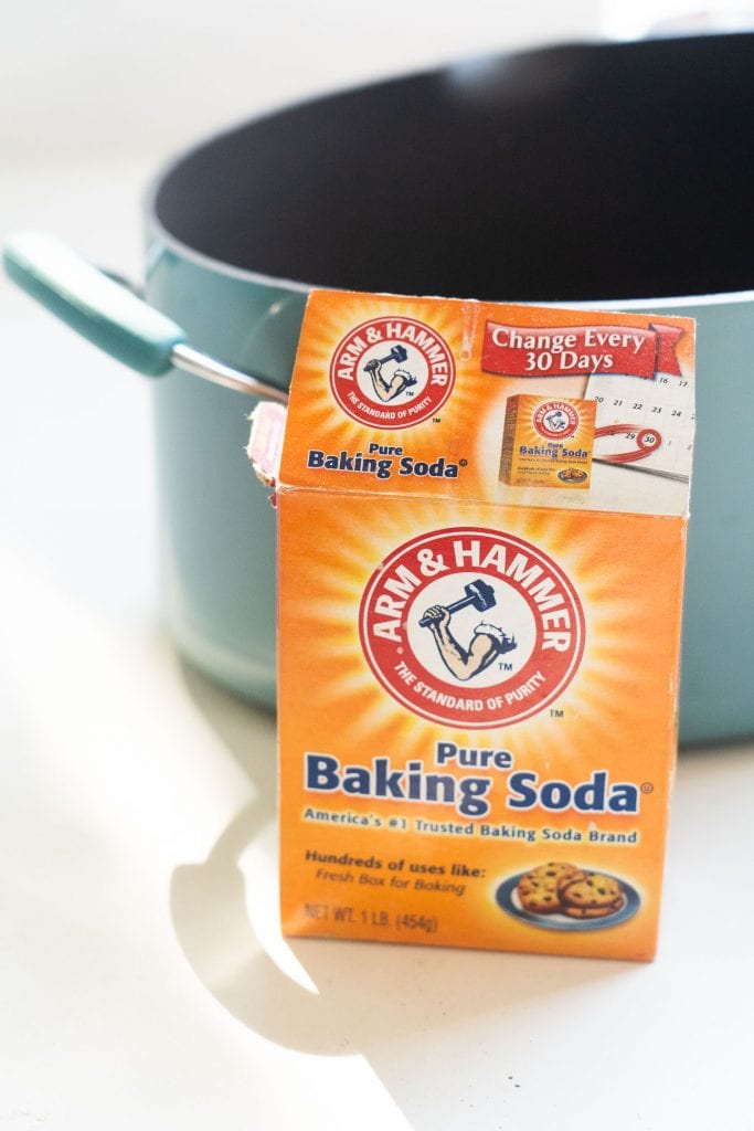 baking soda box in front of large pot filled with water. 