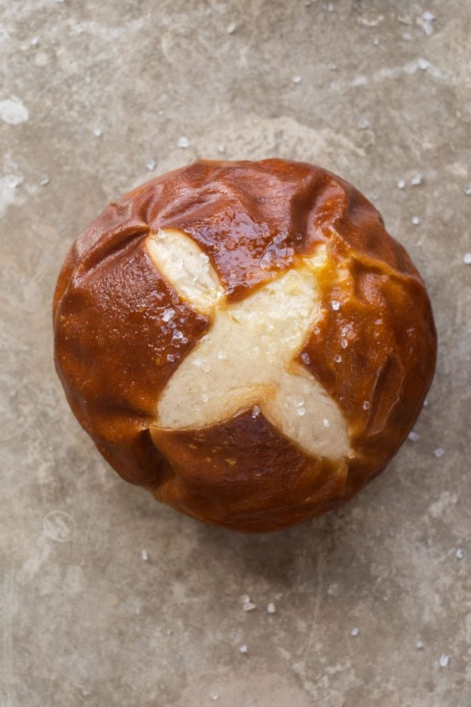 homemade pretzel rolls on baking sheet