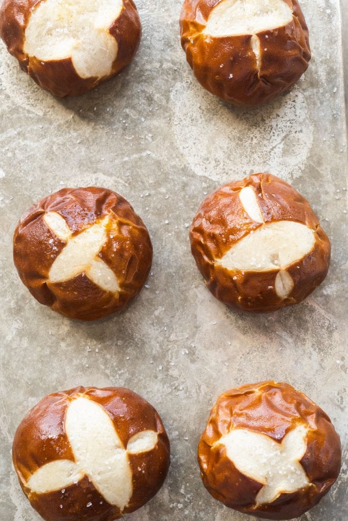 6 perfectly browned pretzel rolls on baking sheet.