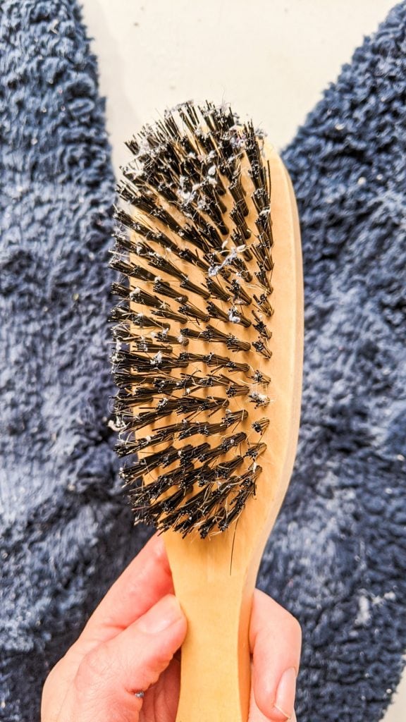 bristle brush covered with lint pieces from sherpa.