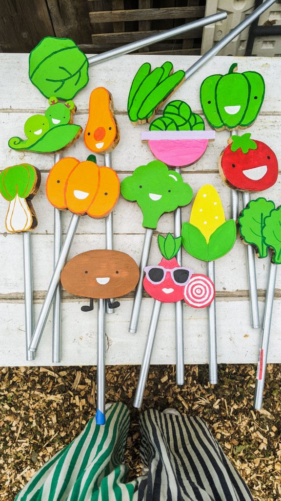 garden signs on metal stakes on white table.