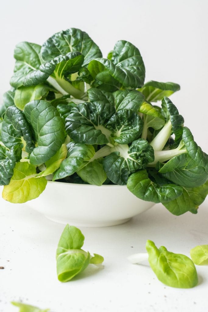 fresh and crunchy bok choy in white bowl on table