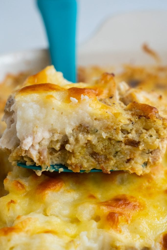 turkey casserole being served from dish on spatula
