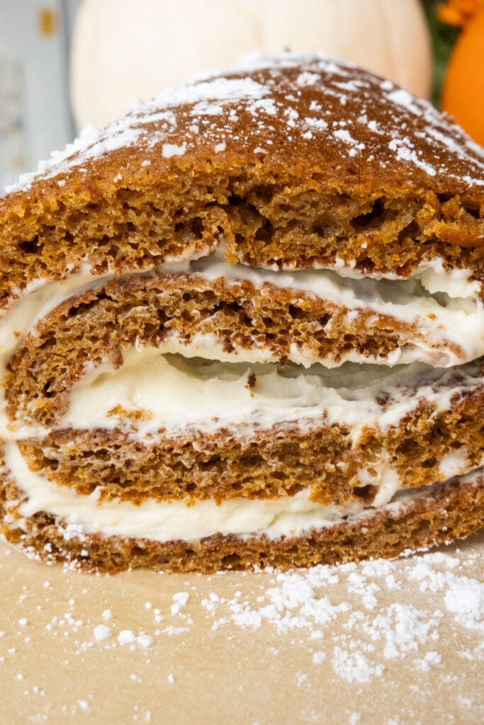 closeup of pumpkin roll with cream cheese filling.