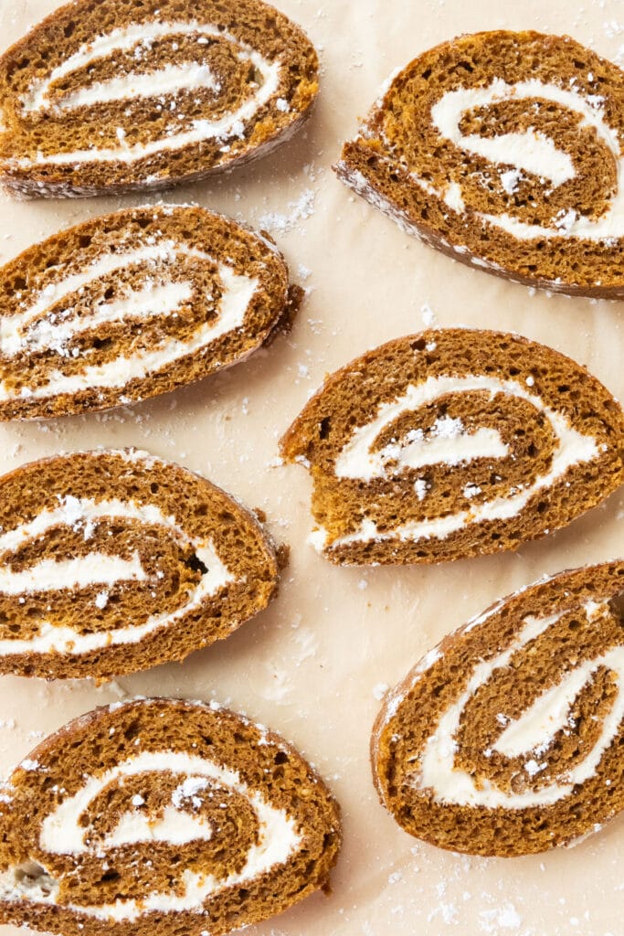 slices of pumpkin roll on parchment paper.