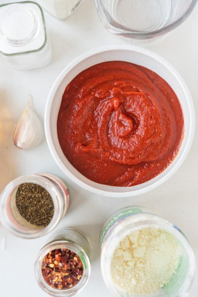 homemade pizza sauce in white bowl on table.
