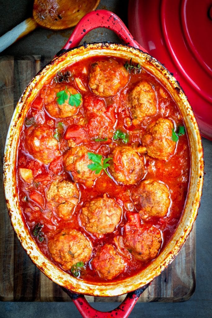oven baked chicken meatballs in tomato sauce in baking dish