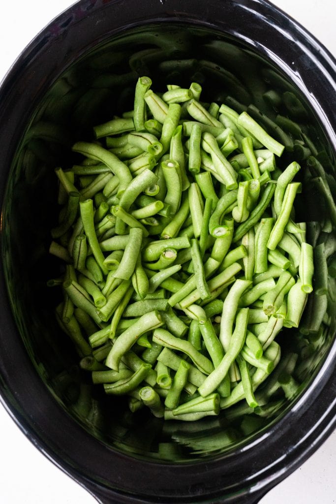 chopped up green beans in slow cooker.