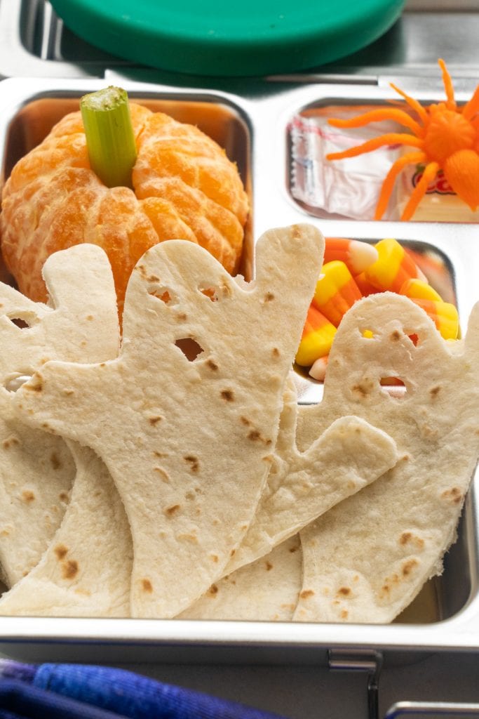 tortillas cut out into ghost shapes in lunch box.