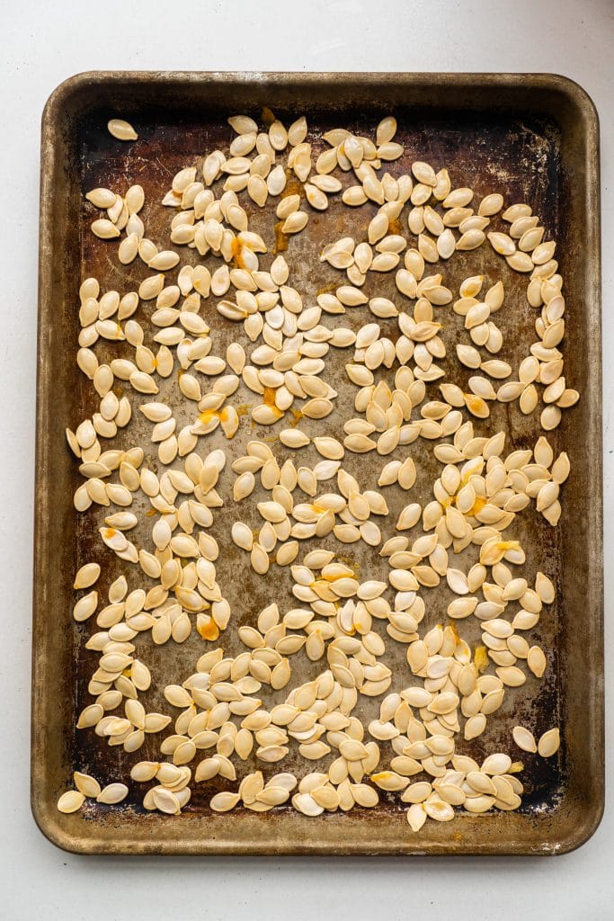 pumpkin seeds on baking sheet.