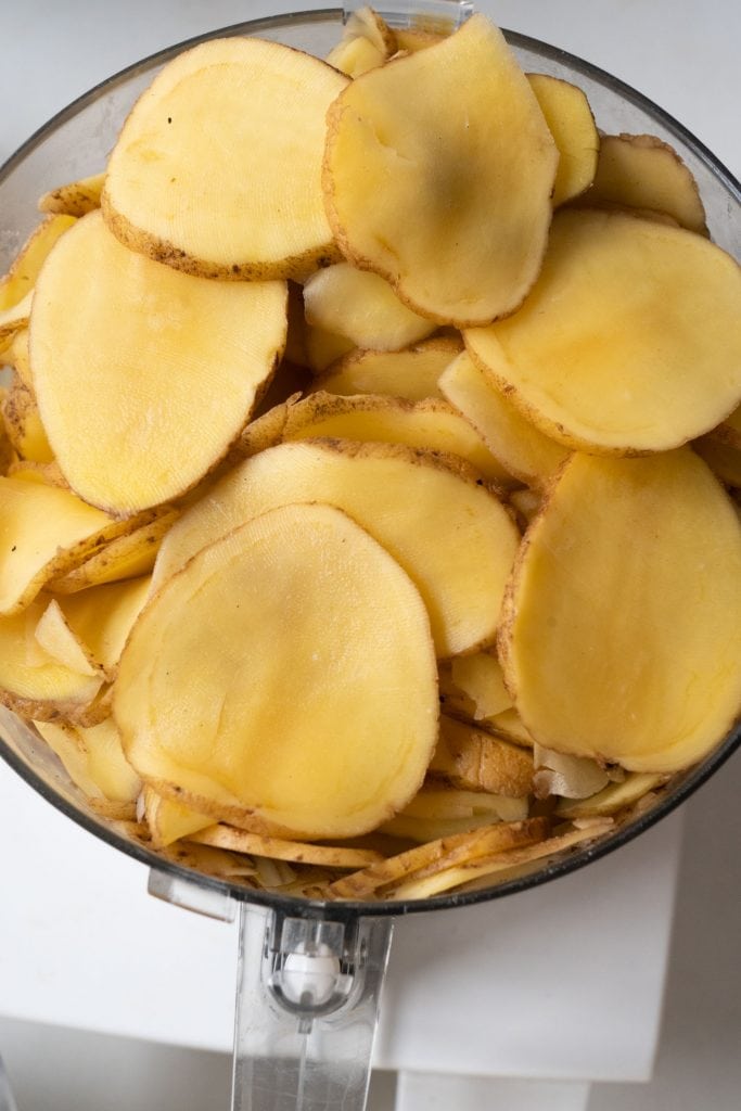 sliced potatoes in food processor.
