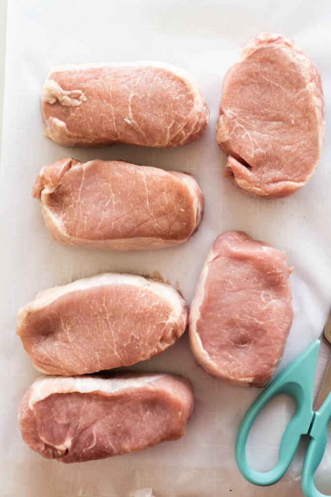 boneless pork chops on parchment paper.