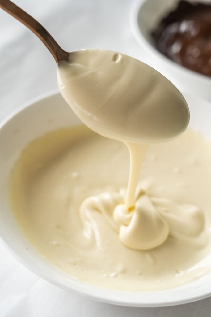 spoon of melted white chocolate