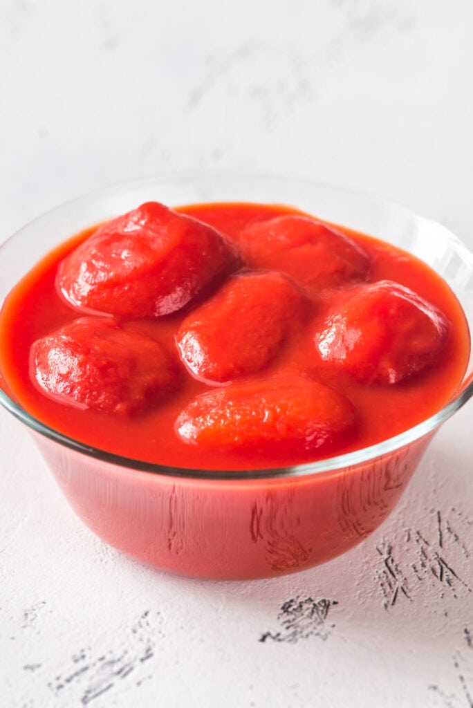 whole peeled tomatoes in glass bowl.