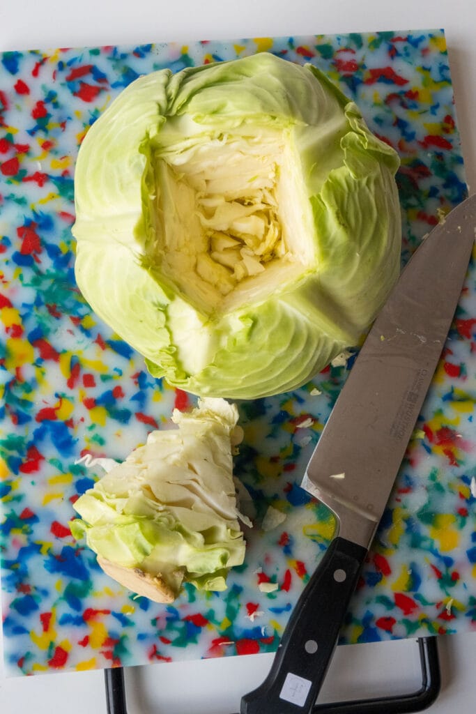 cabbage on cutting board with core removed.