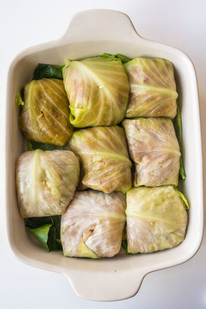 cabbage rolls placed in baking dish.