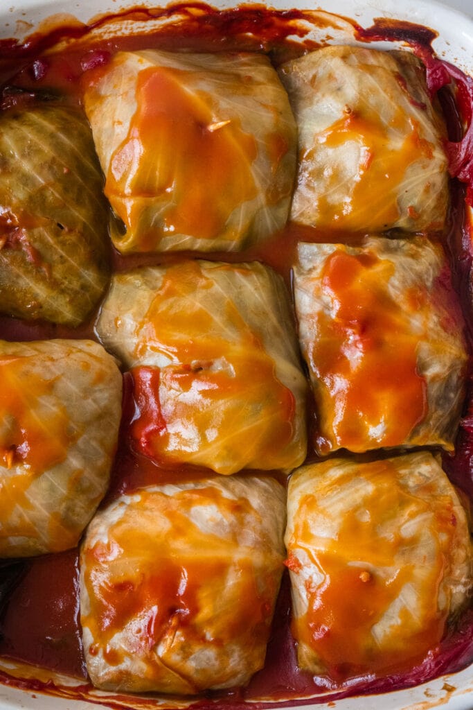 cabbage rolls with tomato sauce on top, ready to serve.