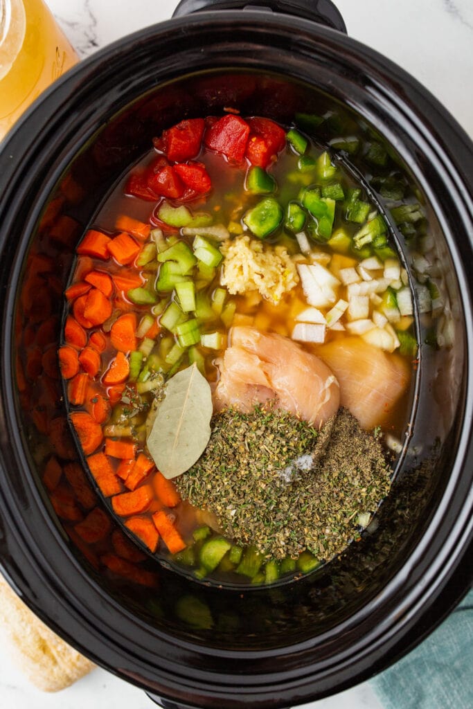 raw ingredients in slow cooker before getting cooked.