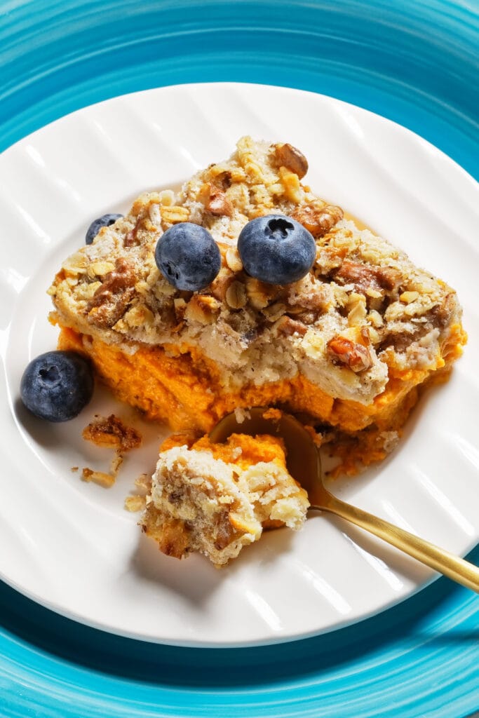 dump cake on plate topped with blueberries.
