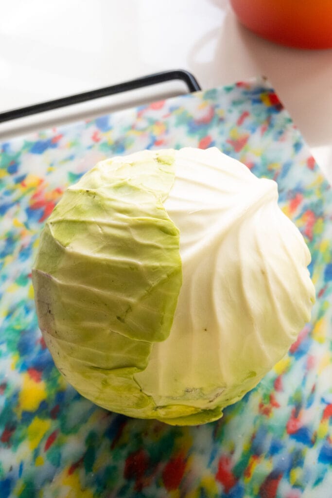 head of cabbage on cutting board.