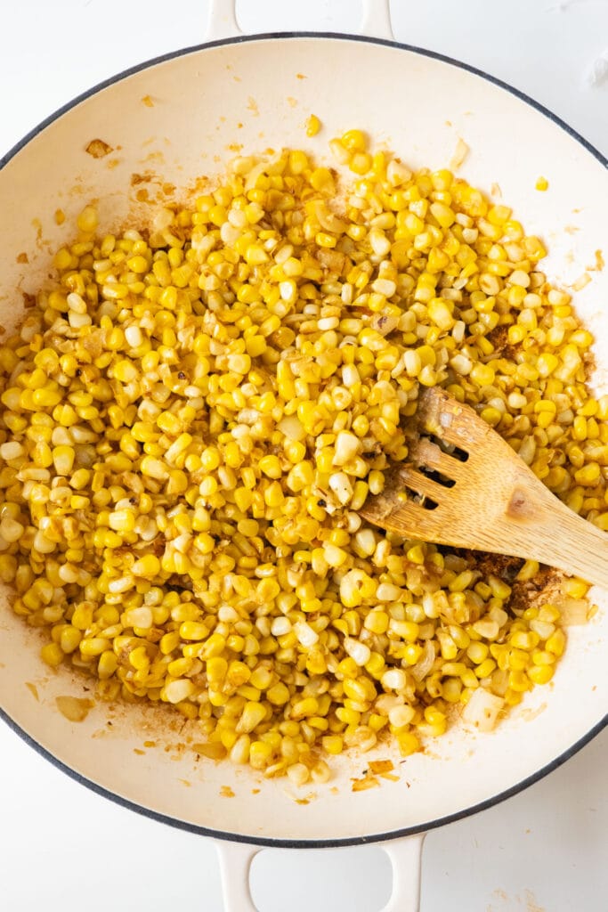 skillet filled with fried corn and onions.