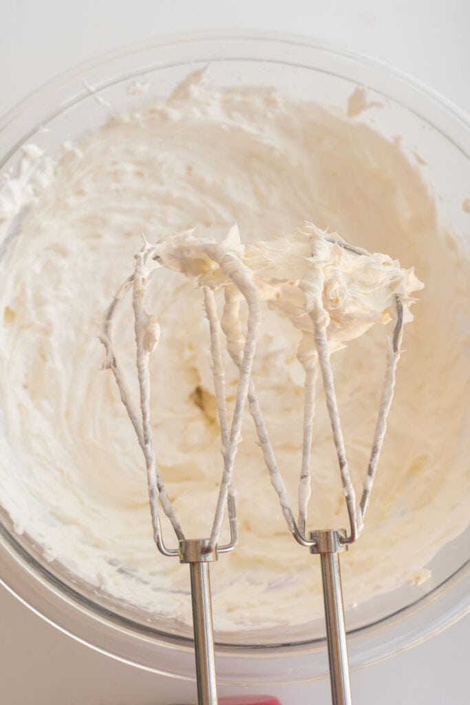 whipped frosting in bowl and on mixers. 