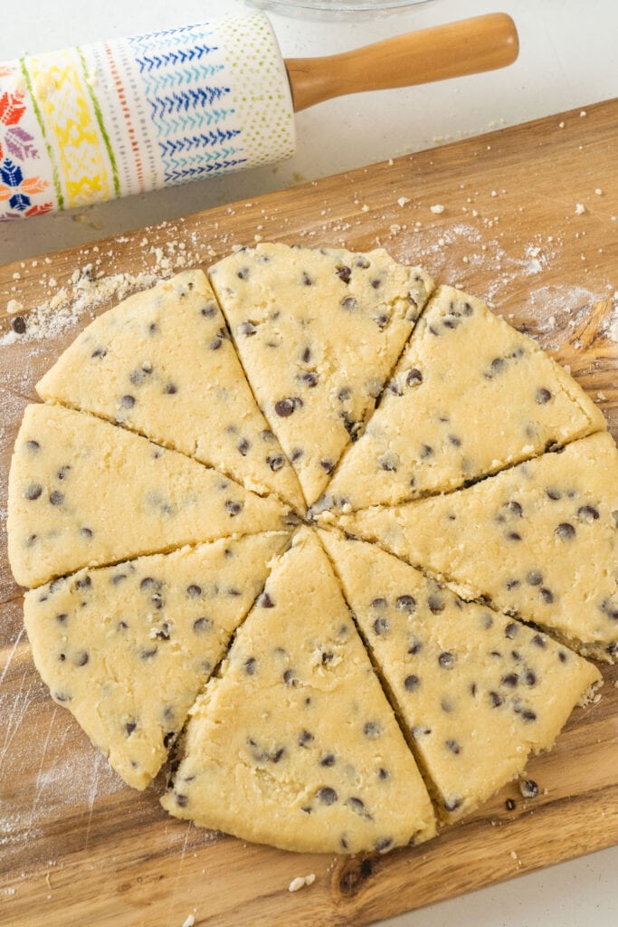dough cut into 8 scones on cutting board. 