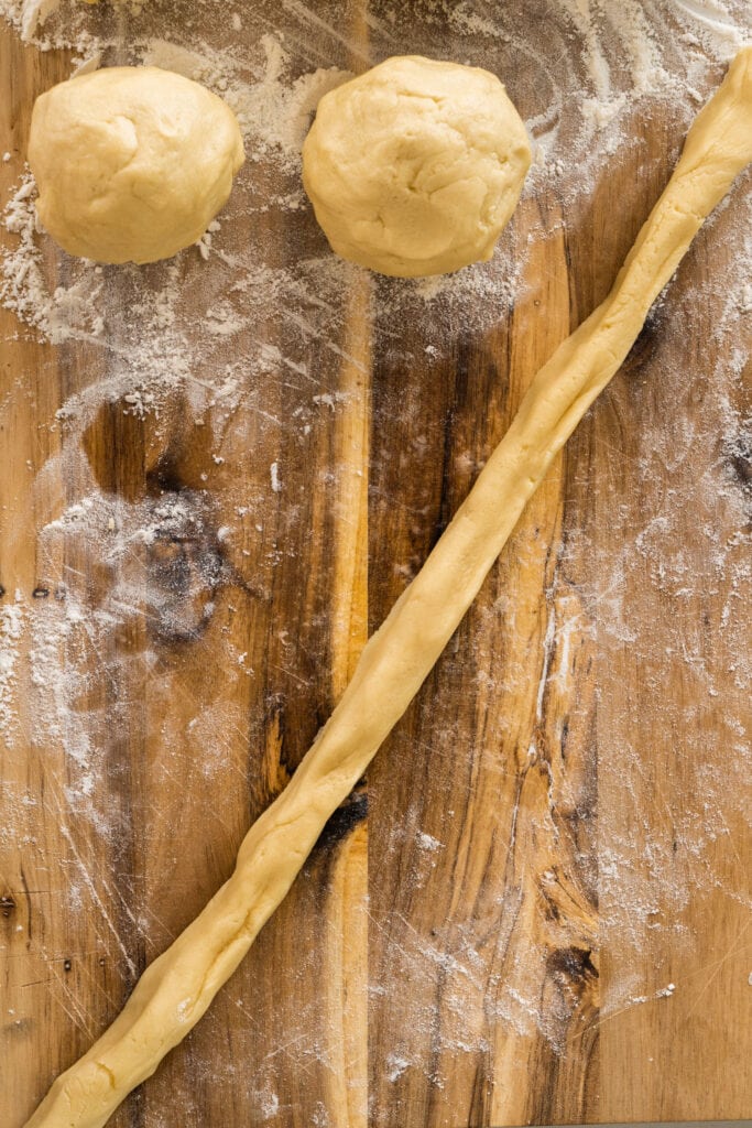 long rope of dough on cutting board.