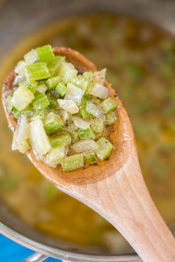 celery and onion in butter on spoon.