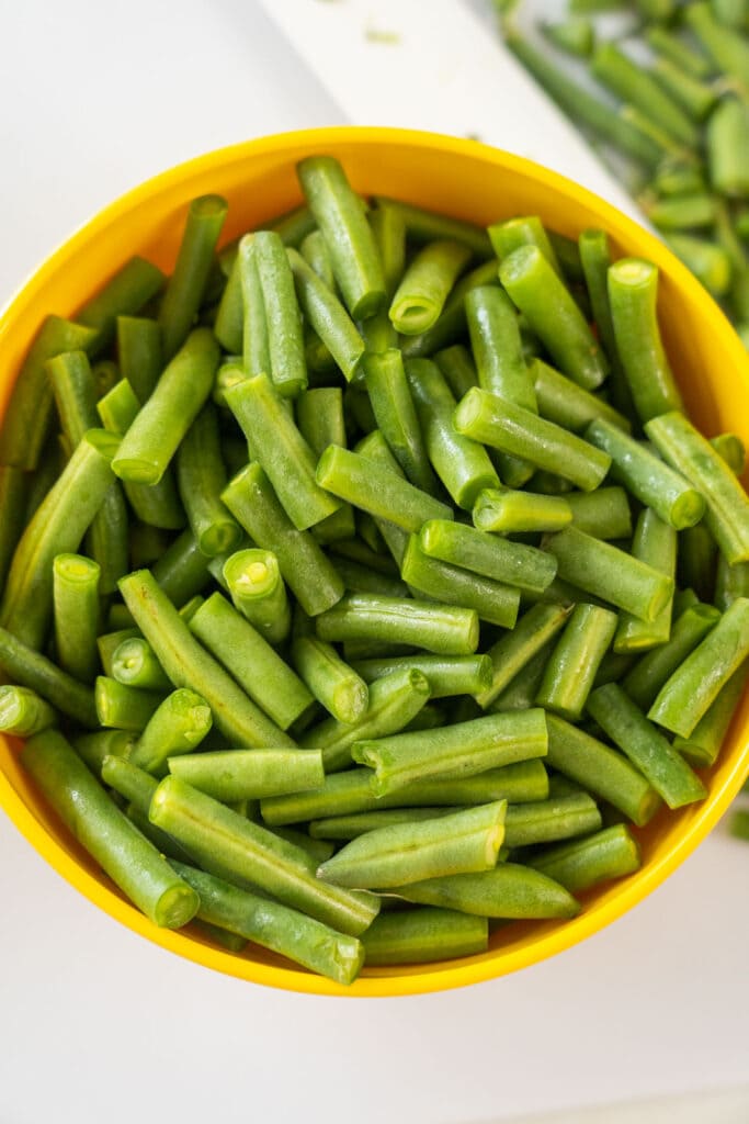 green beans that have been softened in yellow bowl.