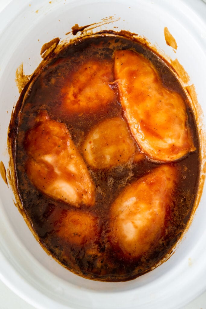 cooked barbecue chicken breasts in slow cooker.