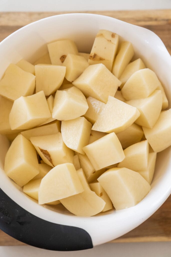cubed and peeled potatoes in bowl. 