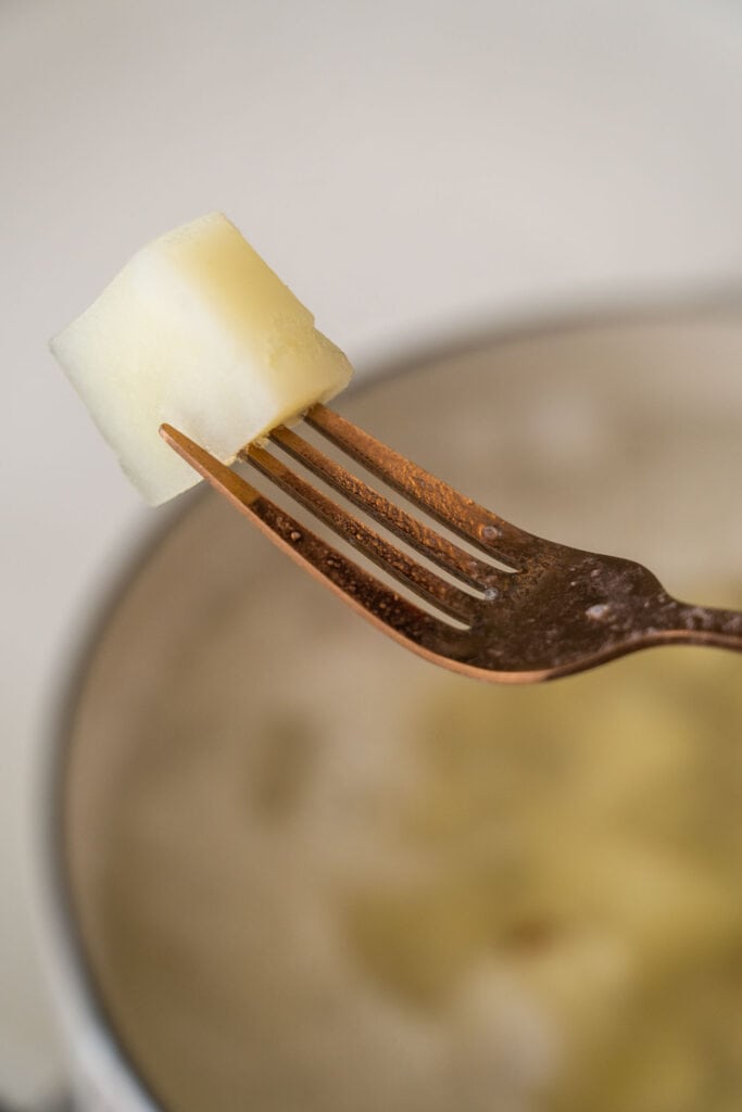 fork holding potato.