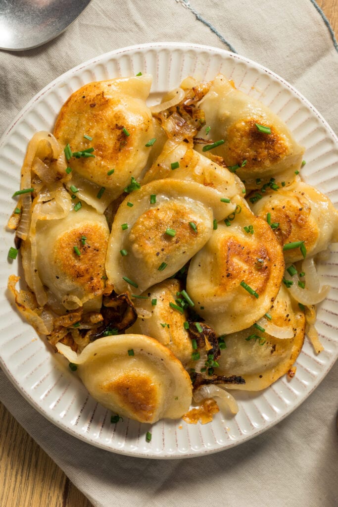 pierogies and cabbage on plate.