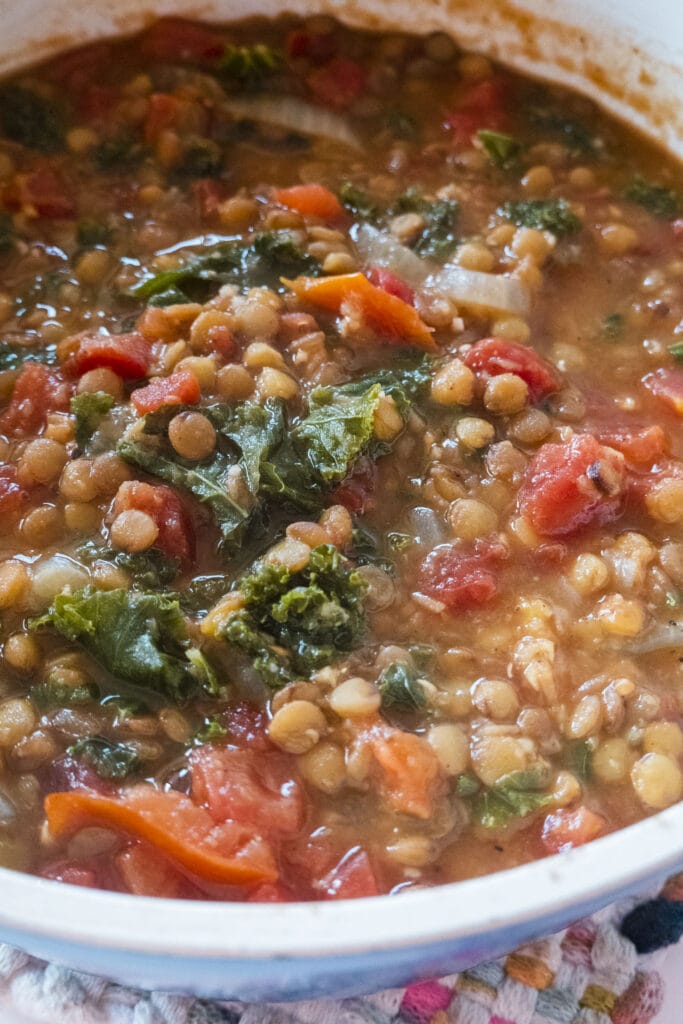 pot of lentils with kale and tomatoes.