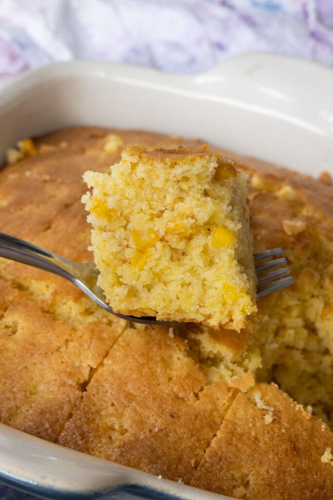 fork lifting cornbread out of baking dish.