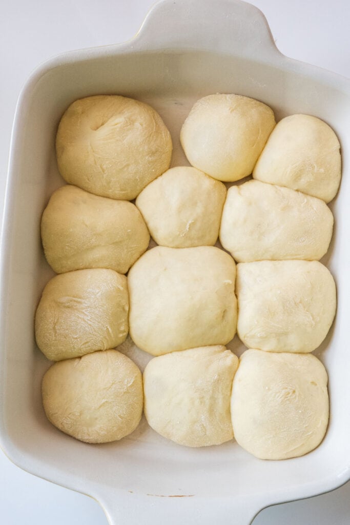 dough balls rising in baking pan.