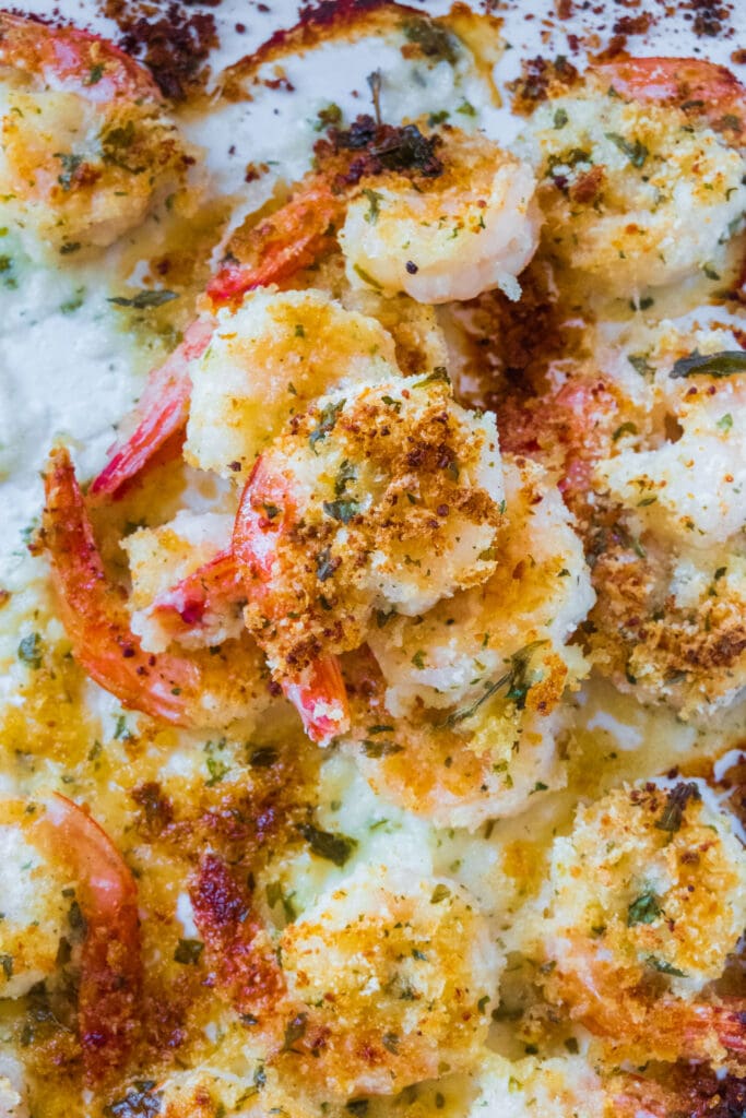 crispy oven baked shrimp stacked on top of each other in baking pan.