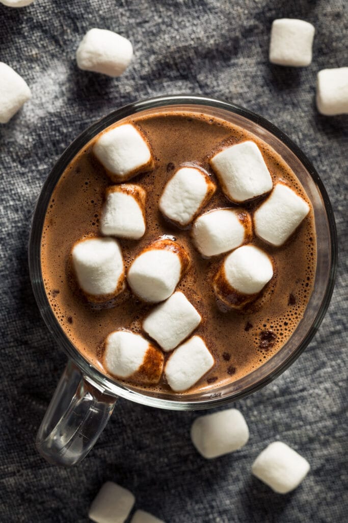 glass of hot chocolate with marshmallows in it.