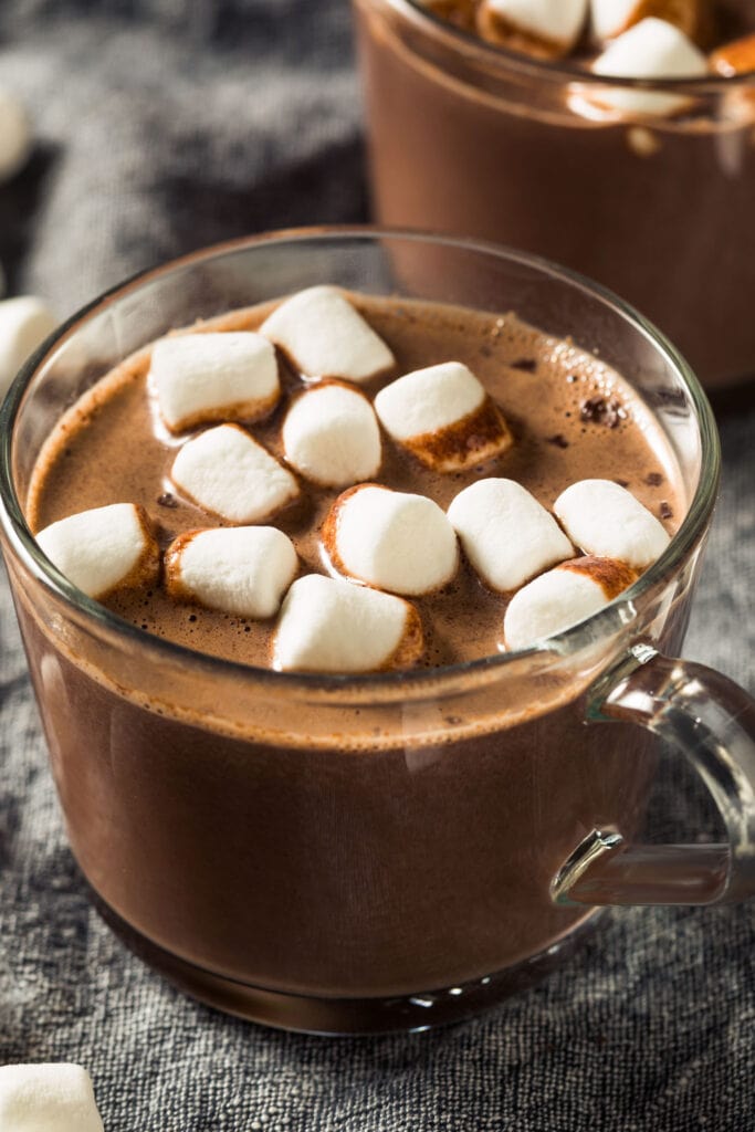 hot chocolate on table with marshmallows.