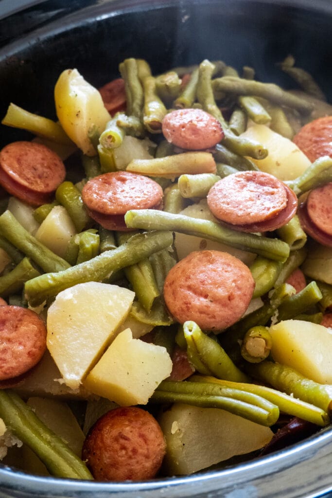 cooked vegetables and kielabasa in slow cooker.