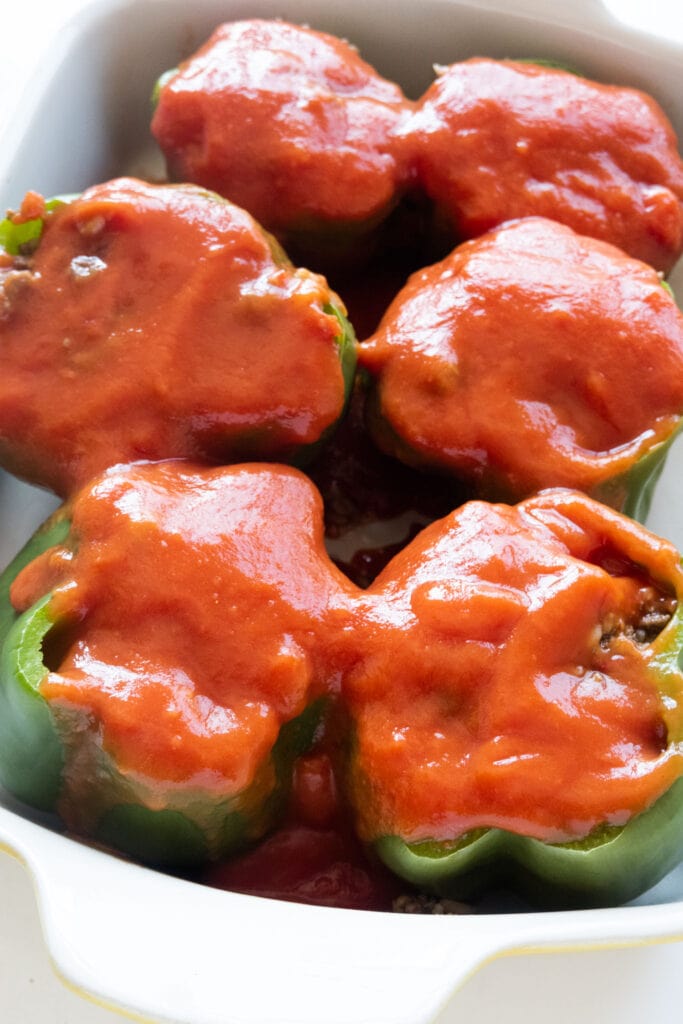 tomato soup sauce on top of peppers.