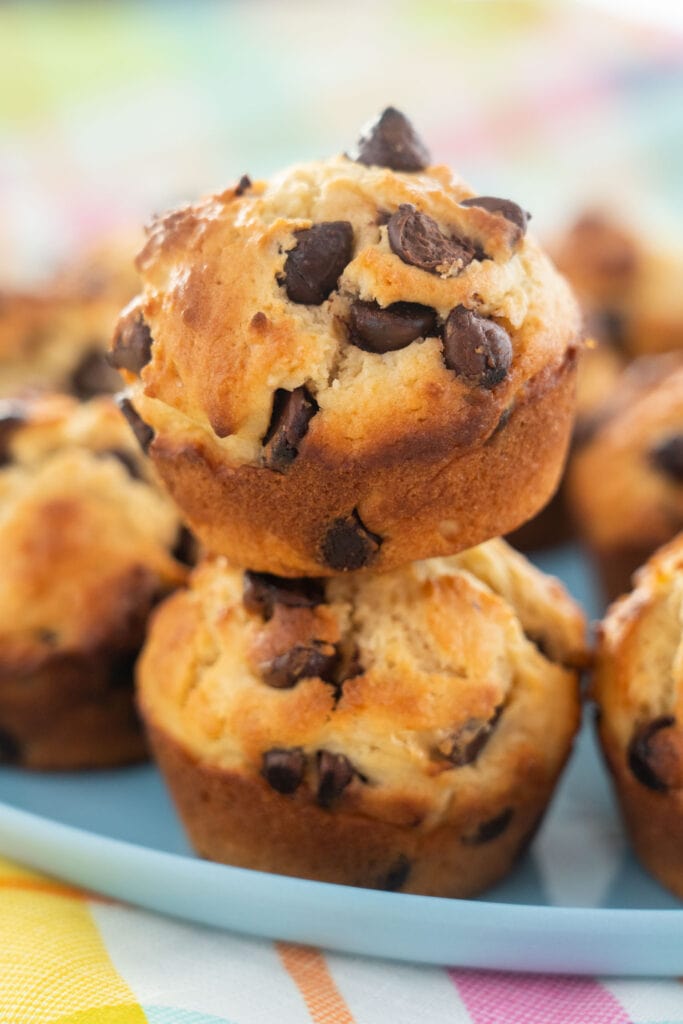 chocolate chip muffins on top of each other on blue plate.